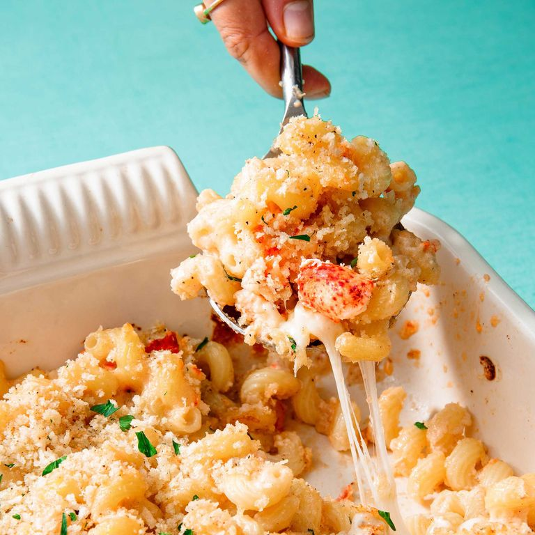 A person is holding a fork over some food.